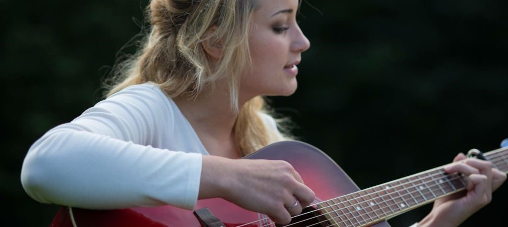 girl playing acoustic guitar