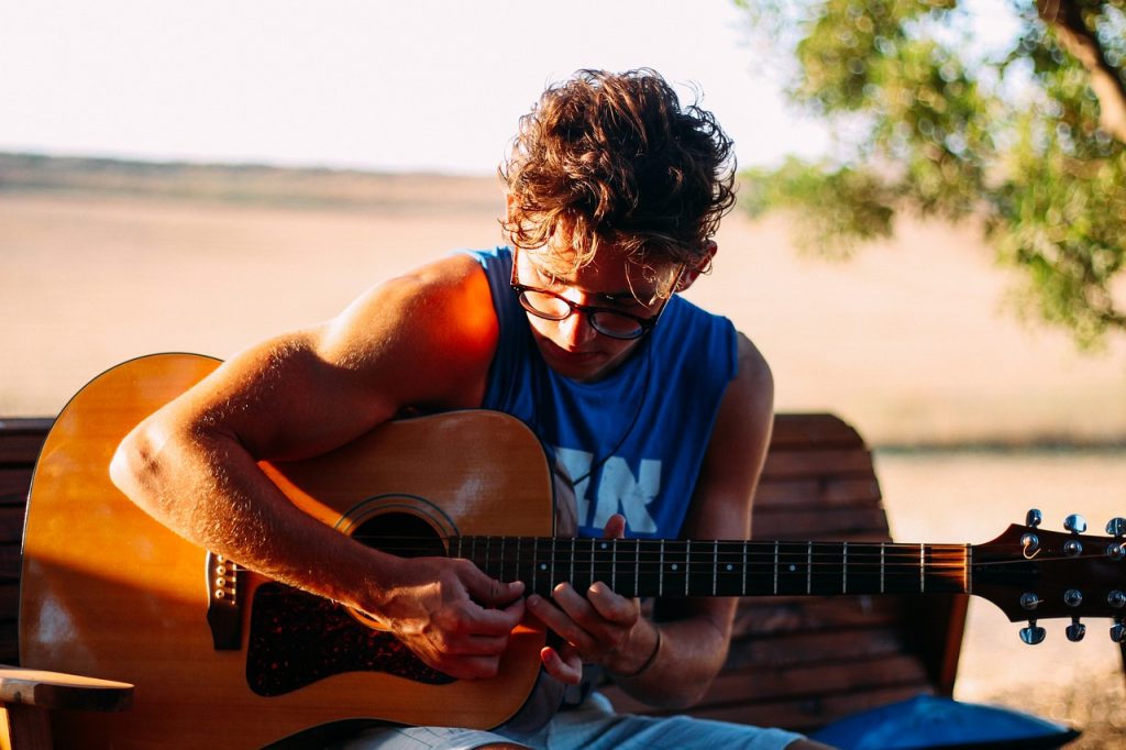 a guy playing acoustic guitar